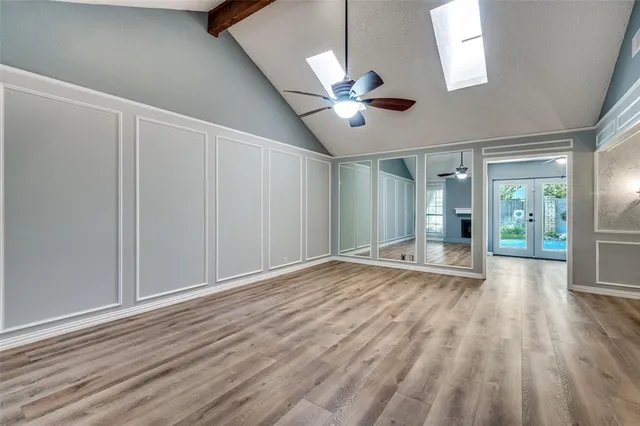 wooden floor in an empty room with a window
