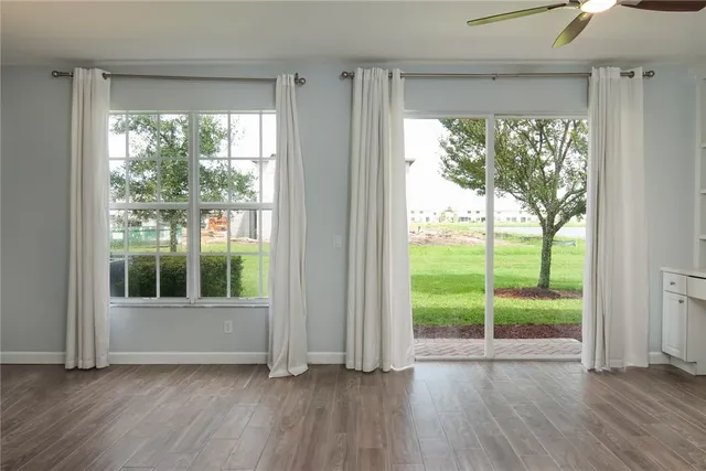 a view of wooden floor and windows in a room