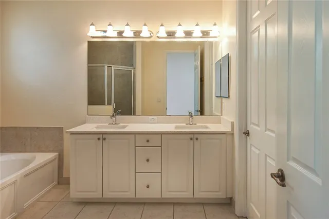 a bathroom with a double vanity sink and a mirror