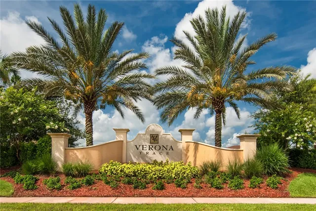 a front view of a house with a tree