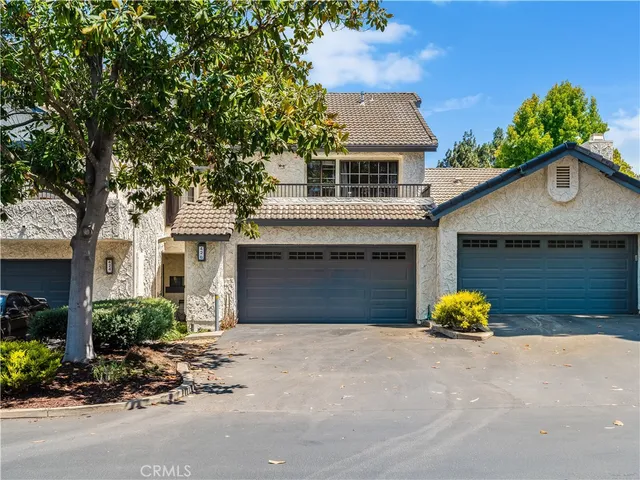 a front view of a house with a yard and a garage