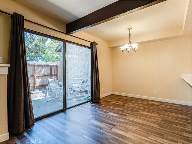 an empty room with wooden floor and door