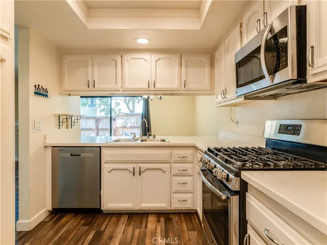 a kitchen with stainless steel appliances granite countertop a stove and a microwave