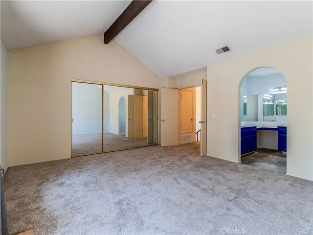 an empty room with mirror and entrance