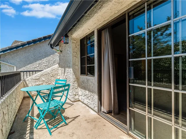 a view of a chairs and table in patio
