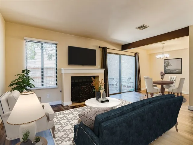 a living room with fireplace furniture and a large window