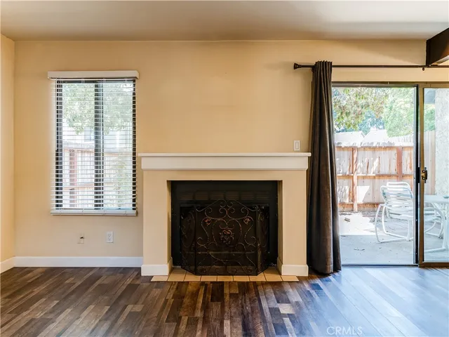 a living room with a fireplace and wooden floor