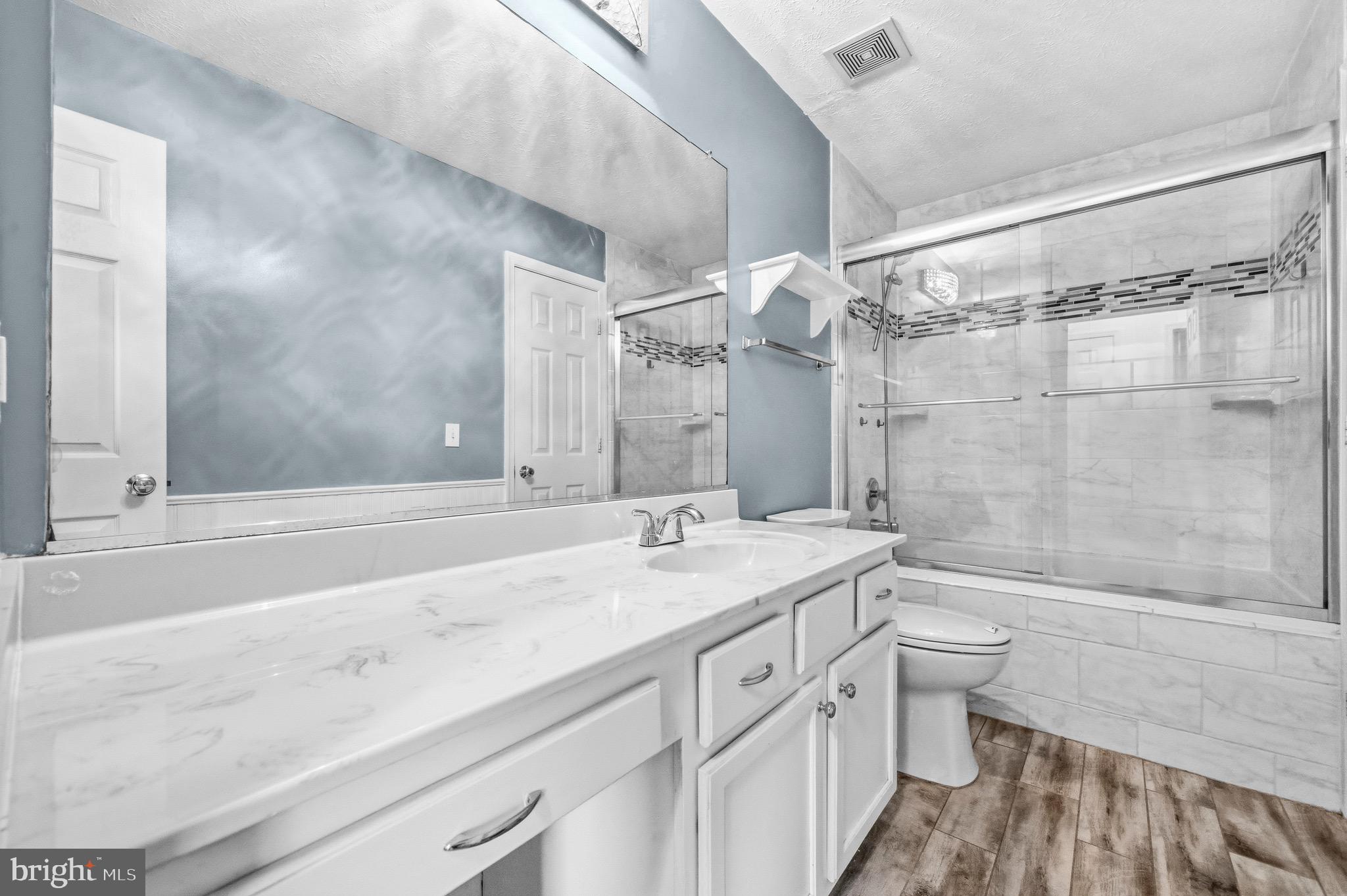 2616 Ruffin Drive Fredericksburg, VA 22408 - Photo 23 of 36 a bathroom with a granite countertop sink a toilet a mirror and shower
