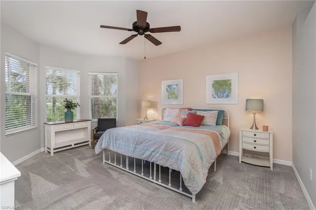 a bedroom with a bed a chandelier and a window