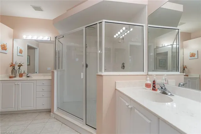 a bathroom with a shower sink vanity and mirror