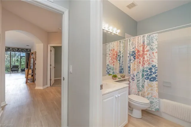 a bathroom with a granite countertop toilet a sink and a shower