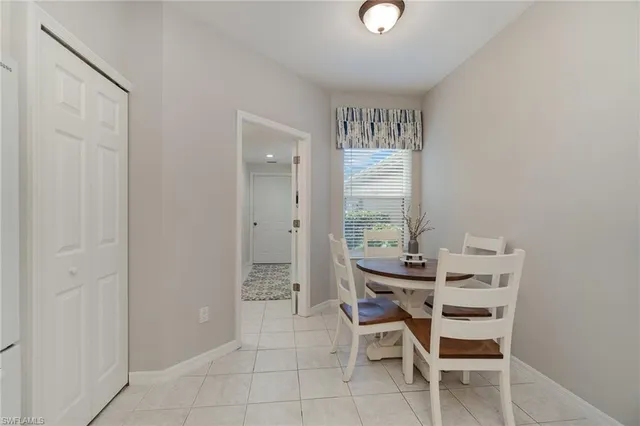 a kitchen with white cabinets and refrigerator