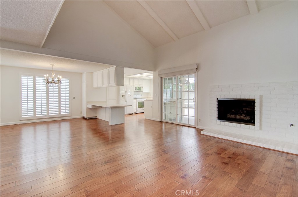 10091 Saltair Drive Cypress, CA 90630 - Photo 15 of 42 a view of an empty room with wooden floor and a fireplace