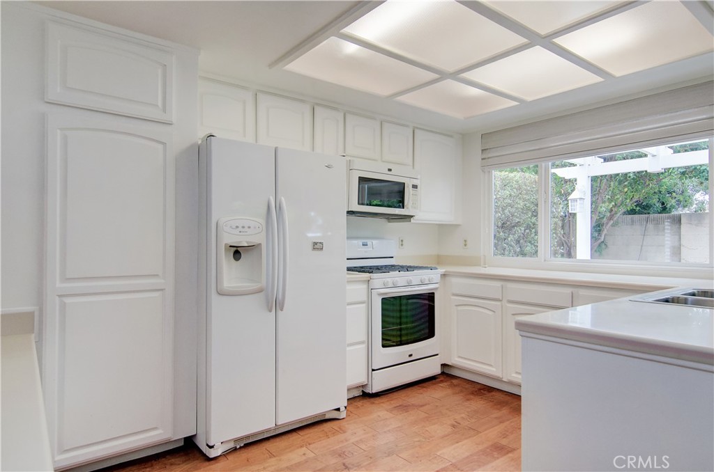 10091 Saltair Drive Cypress, CA 90630 - Photo 19 of 42 a kitchen with stainless steel appliances a stove a sink and a refrigerator
