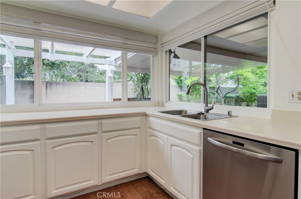 10091 Saltair Drive Cypress, CA 90630 - Photo 21 of 42 a kitchen with white cabinets and a large window