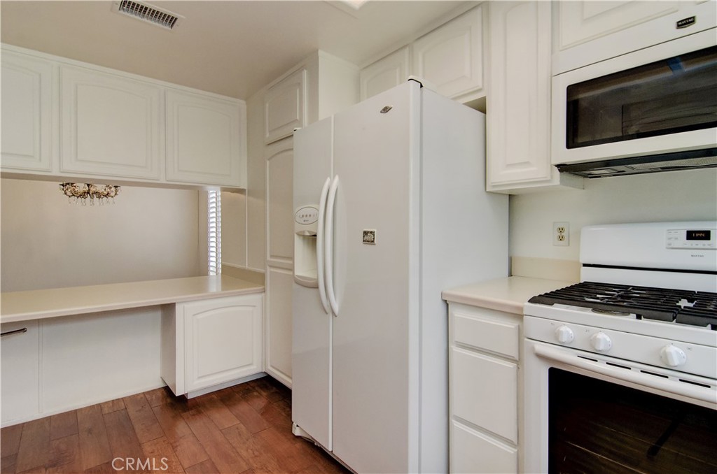 10091 Saltair Drive Cypress, CA 90630 - Photo 22 of 42 a kitchen with cabinets and steel stainless steel appliances
