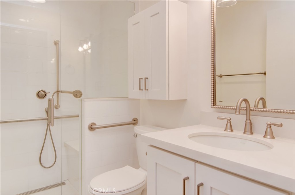 10091 Saltair Drive Cypress, CA 90630 - Photo 30 of 42 a bathroom with a sink toilet and shower