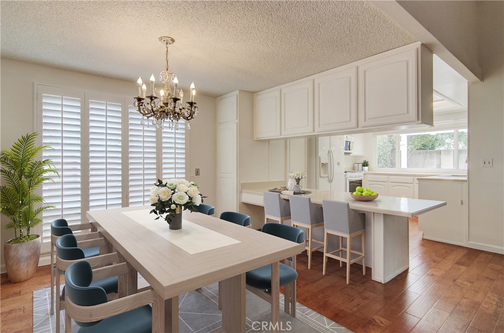 10091 Saltair Drive Cypress, CA 90630 - Photo 3 of 42 a view of a dining room with furniture window and wooden floor