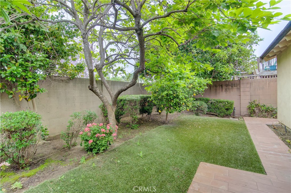 10091 Saltair Drive Cypress, CA 90630 - Photo 39 of 42 a backyard of a house with lots of green space and fountain