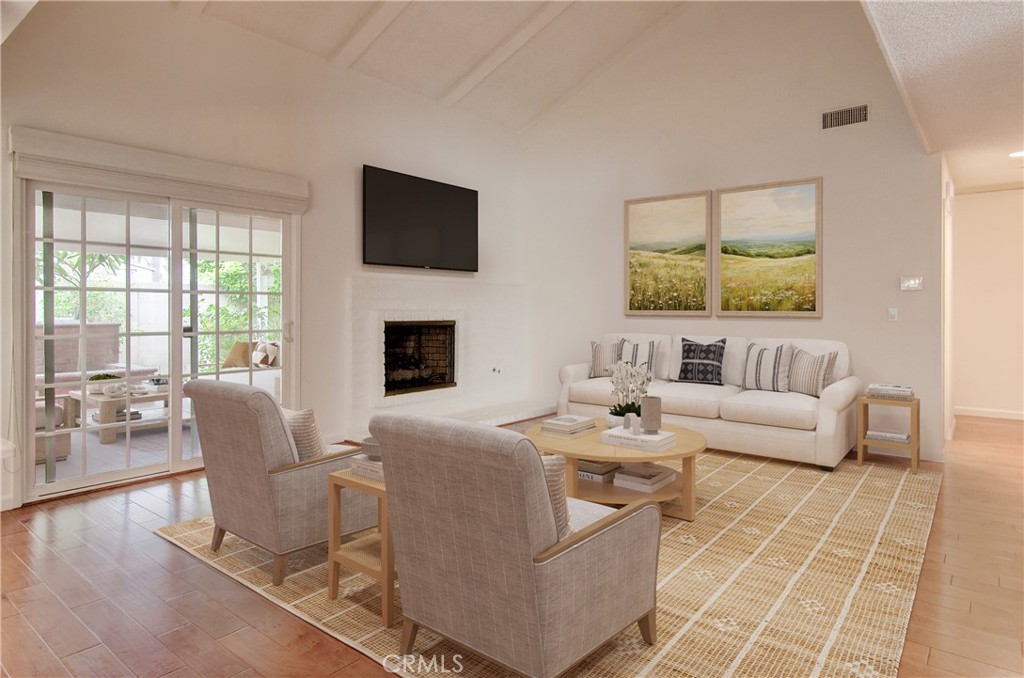 10091 Saltair Drive Cypress, CA 90630 - Photo 4 of 42 a living room with fireplace furniture and a flat screen tv