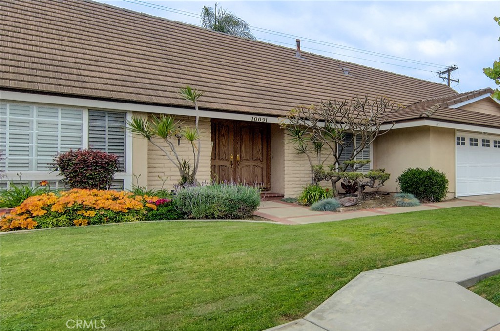 10091 Saltair Drive Cypress, CA 90630 - Photo 8 of 42 a front view of a house with garden and plants