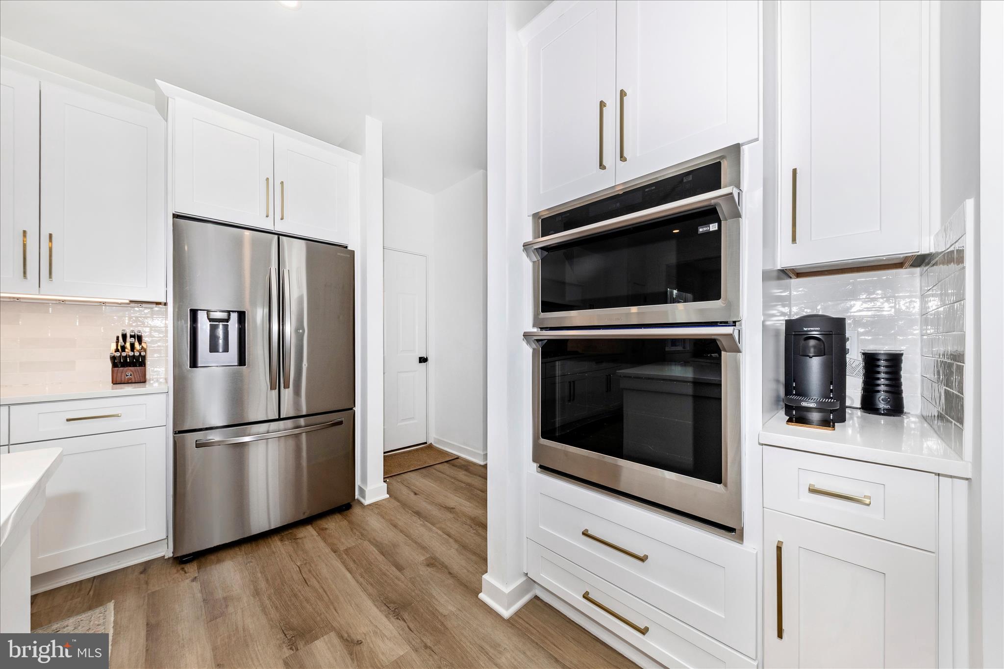 14105 Peddicord Road Mount Airy, MD 21771 - Photo 12 of 52 a kitchen with cabinets stainless steel appliances and wooden floor