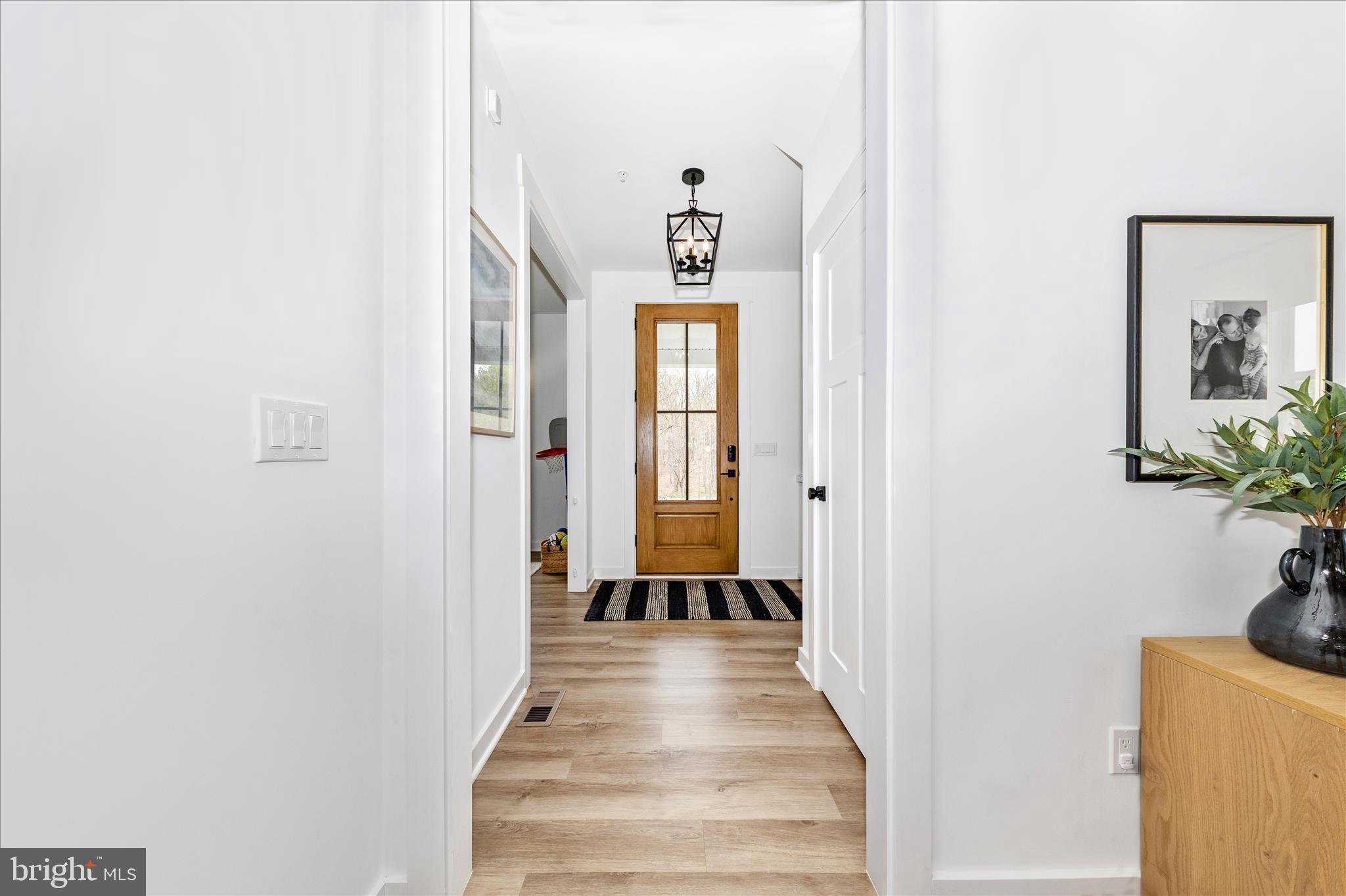 14105 Peddicord Road Mount Airy, MD 21771 - Photo 2 of 52 a view of a hallway with wooden floor and a potted plant