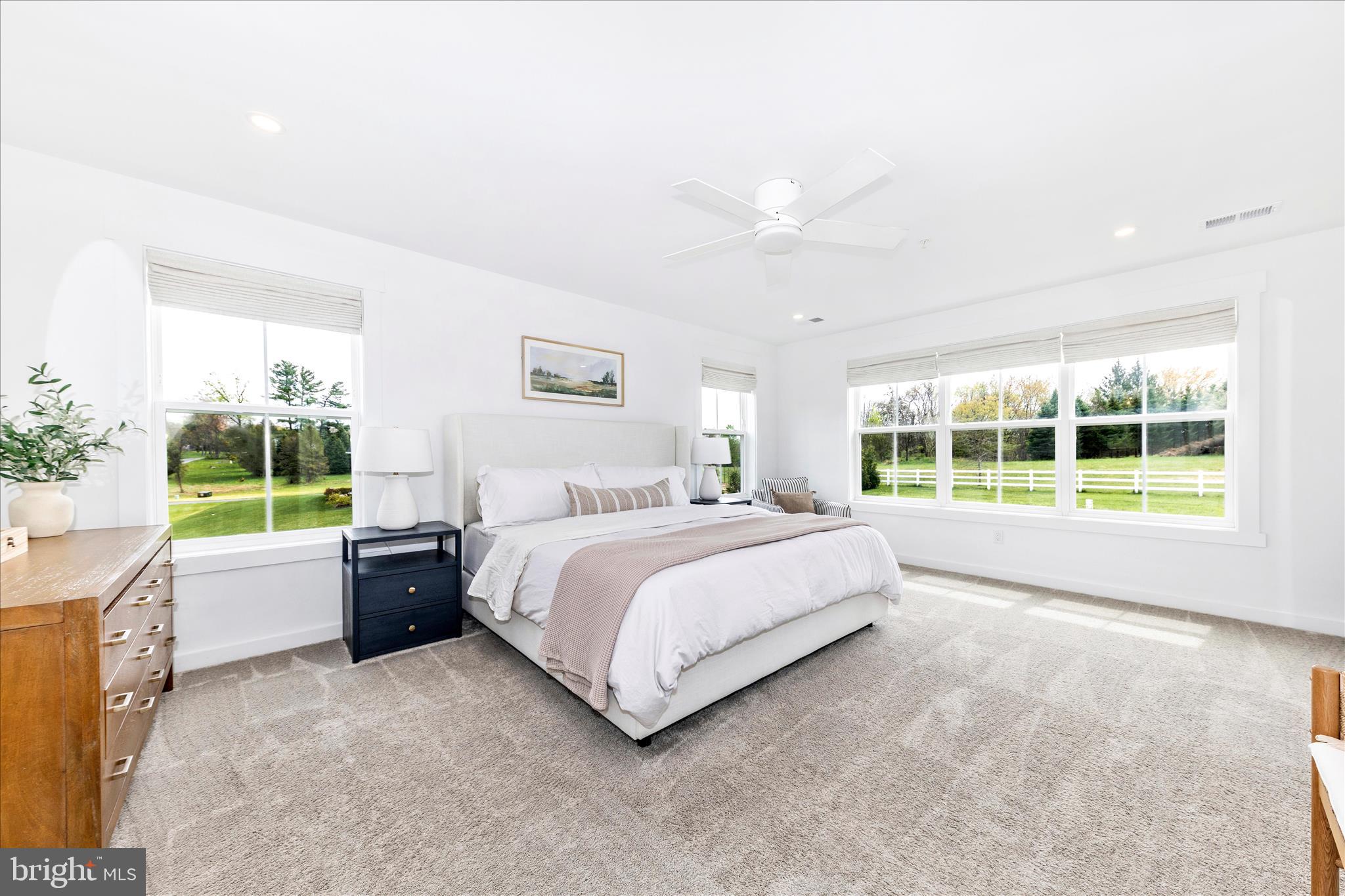 14105 Peddicord Road Mount Airy, MD 21771 - Photo 21 of 52 a spacious bedroom with a large bed and a large window
