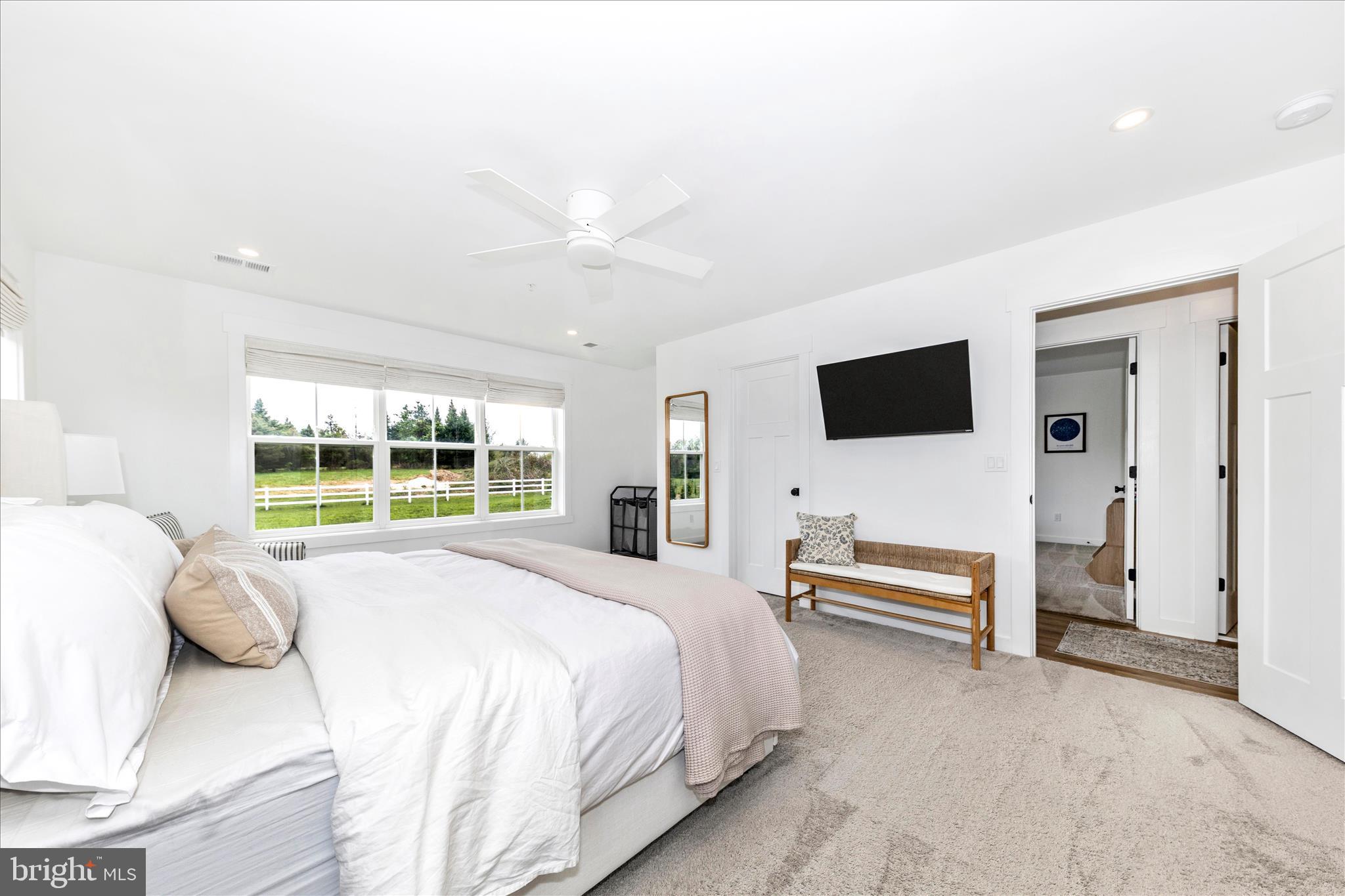 14105 Peddicord Road Mount Airy, MD 21771 - Photo 22 of 52 a spacious bedroom with a large bed and a flat tv screen