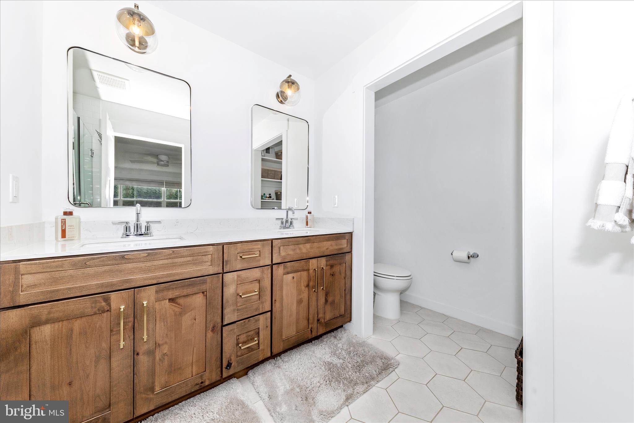 14105 Peddicord Road Mount Airy, MD 21771 - Photo 23 of 52 a spacious bathroom with a double vanity sink a mirror and a