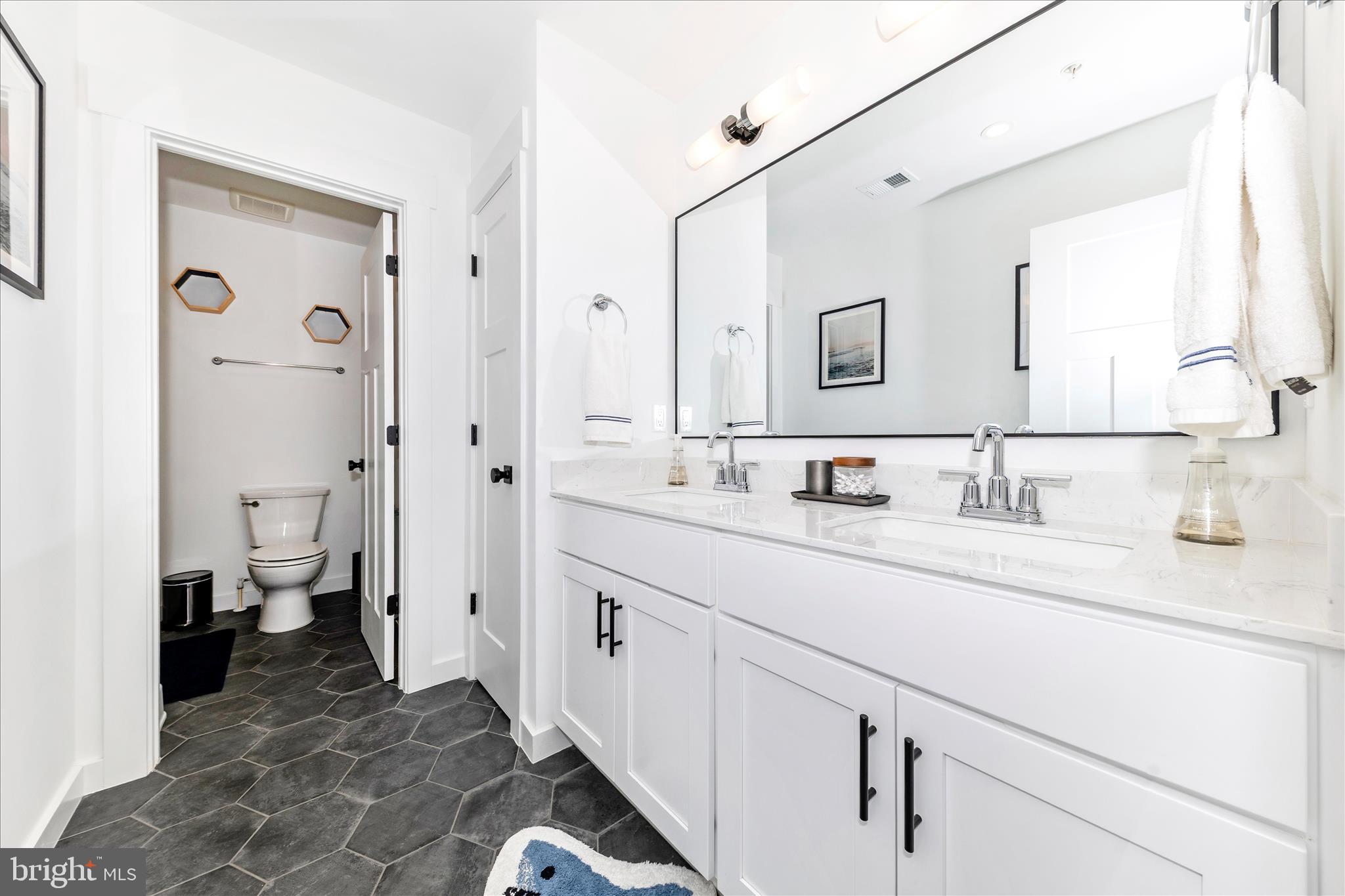 14105 Peddicord Road Mount Airy, MD 21771 - Photo 27 of 52 a spacious bathroom with a sink and a mirror