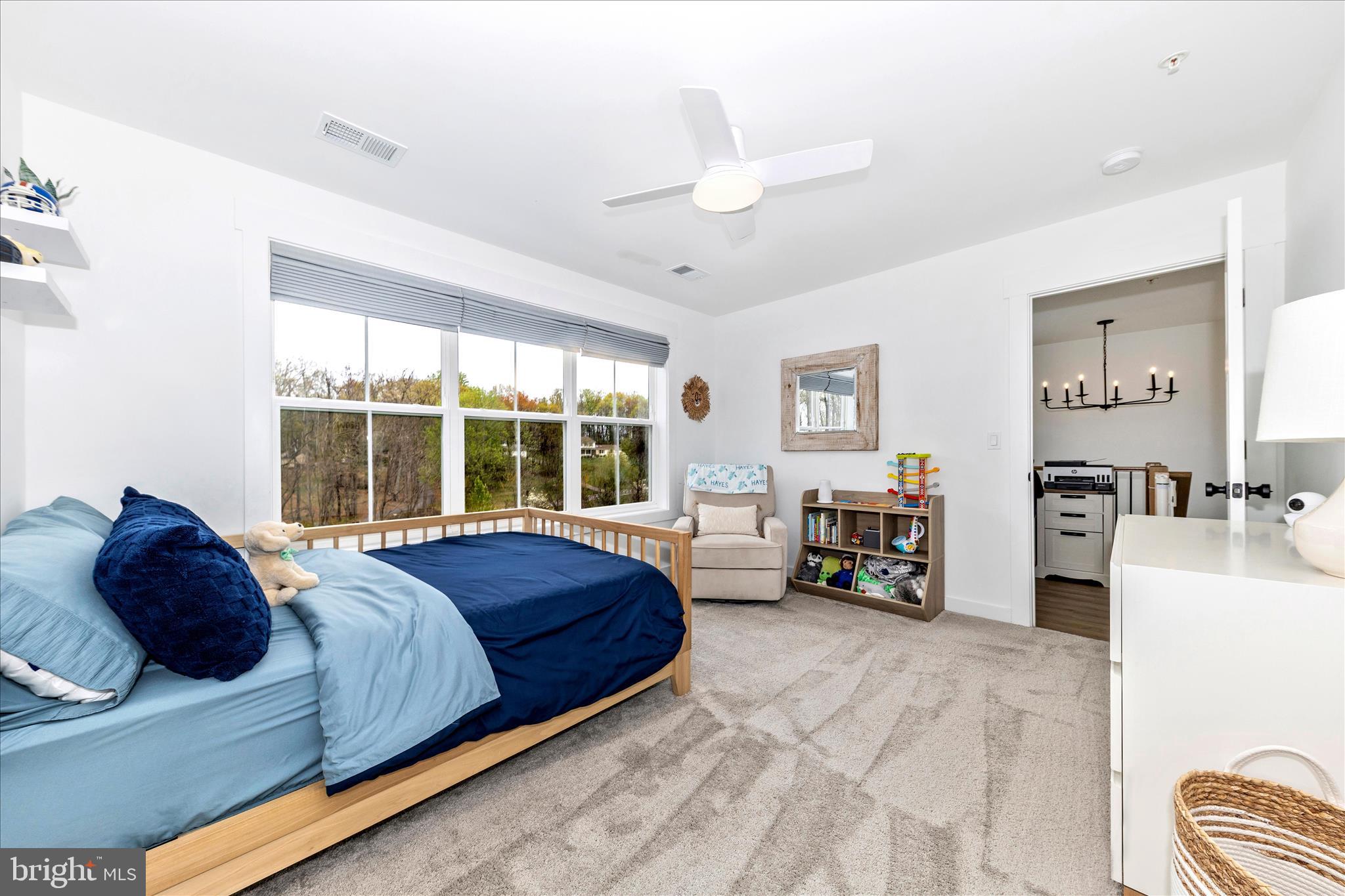 14105 Peddicord Road Mount Airy, MD 21771 - Photo 29 of 52 a spacious bedroom with a bed couch and a large window