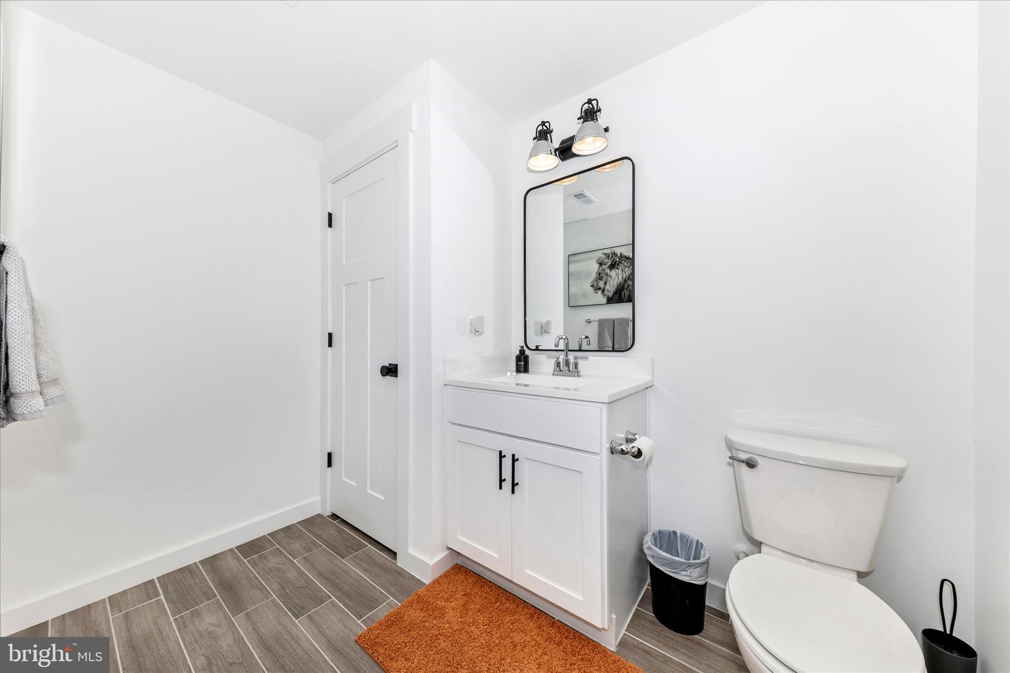14105 Peddicord Road Mount Airy, MD 21771 - Photo 37 of 52 a bathroom with a toilet sink and mirror