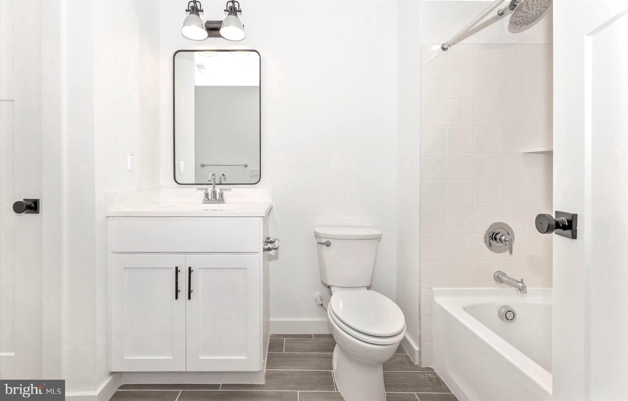 14105 Peddicord Road Mount Airy, MD 21771 - Photo 38 of 52 a bathroom with a sink a toilet and shower