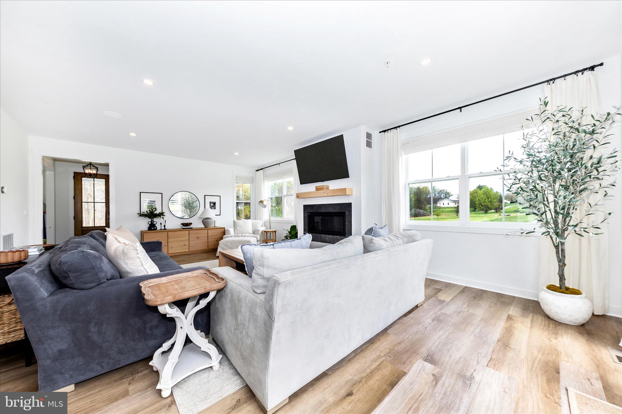 14105 Peddicord Road Mount Airy, MD 21771 - Photo 4 of 52 a living room with furniture a flat screen tv and a fireplace