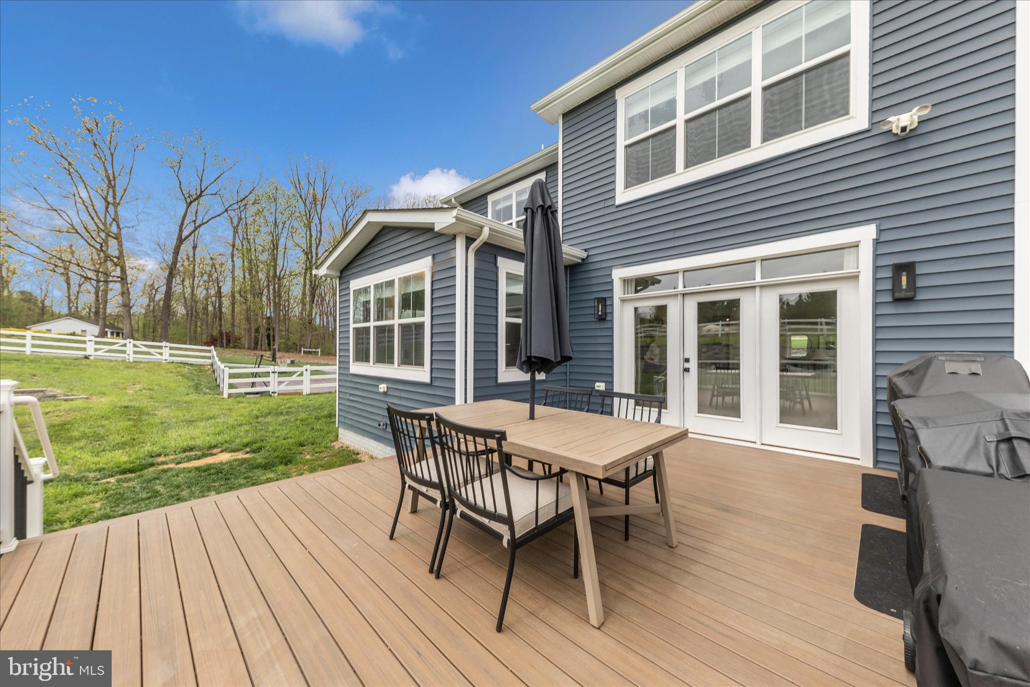 14105 Peddicord Road Mount Airy, MD 21771 - Photo 52 of 52 a roof deck with table and chairs and wooden floor