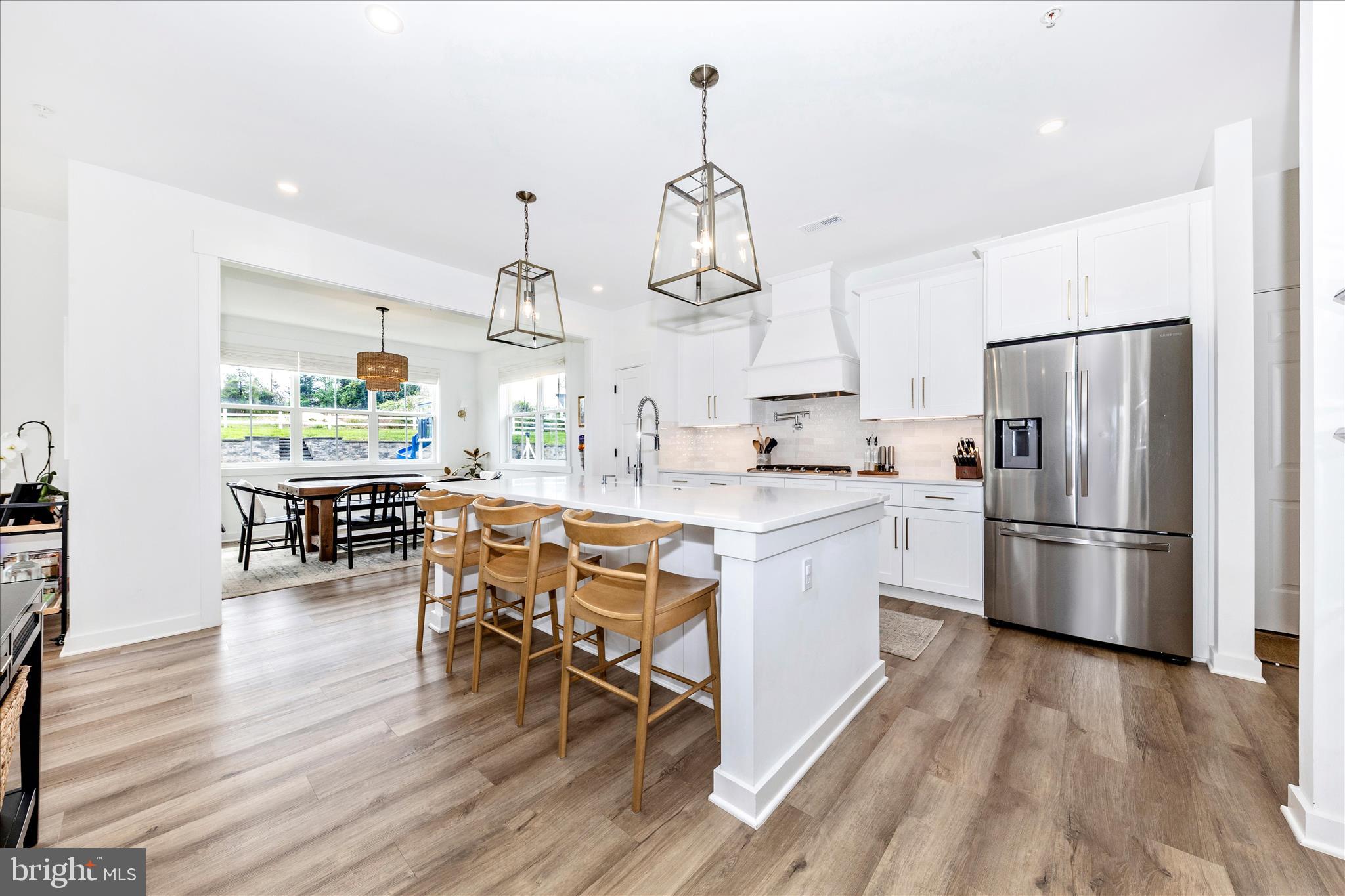 14105 Peddicord Road Mount Airy, MD 21771 - Photo 7 of 52 a kitchen with stainless steel appliances a dining table chairs stove refrigerator and cabinets