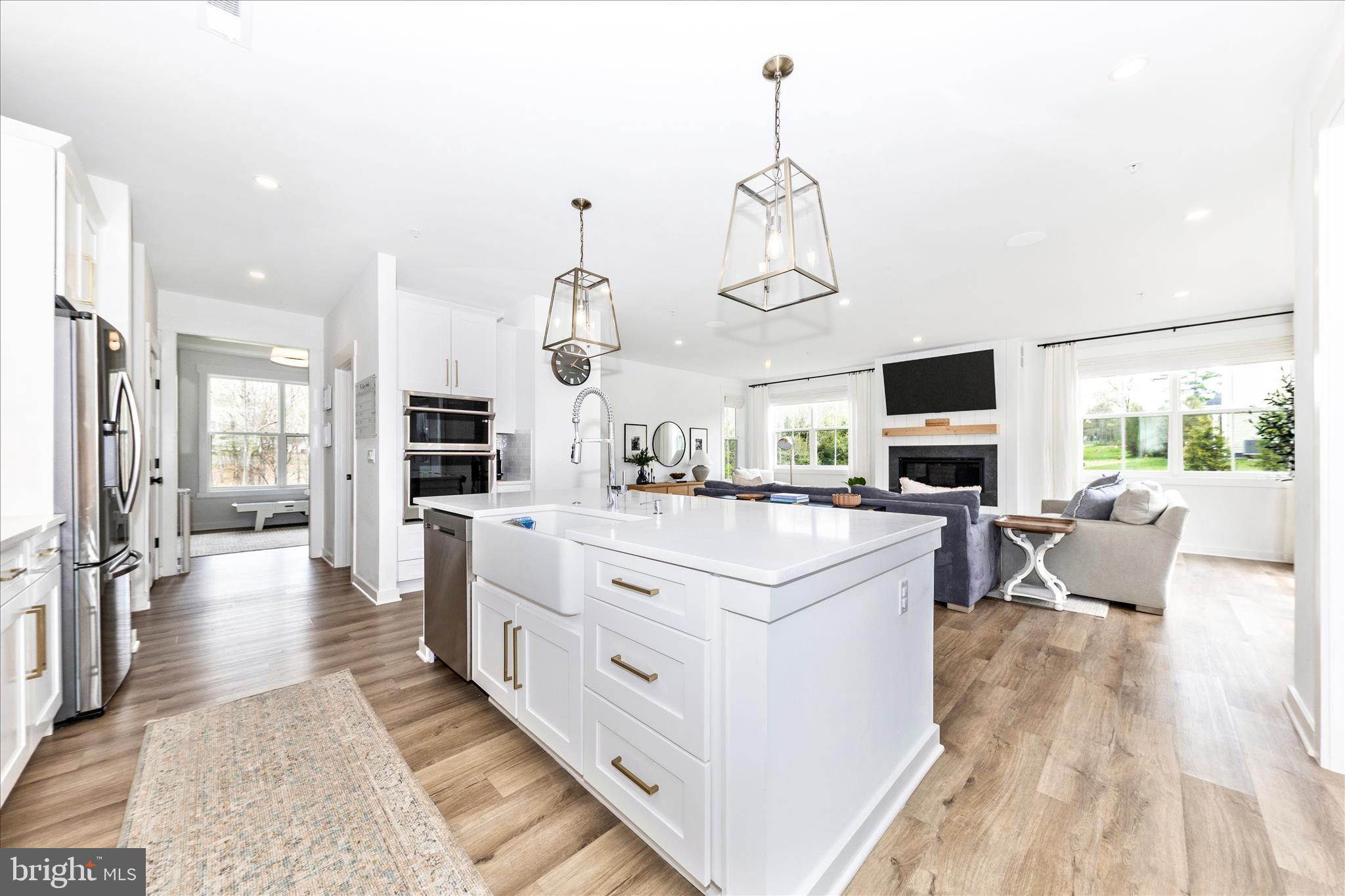 14105 Peddicord Road Mount Airy, MD 21771 - Photo 9 of 52 a large kitchen with kitchen island a large counter space a sink appliances and living room view