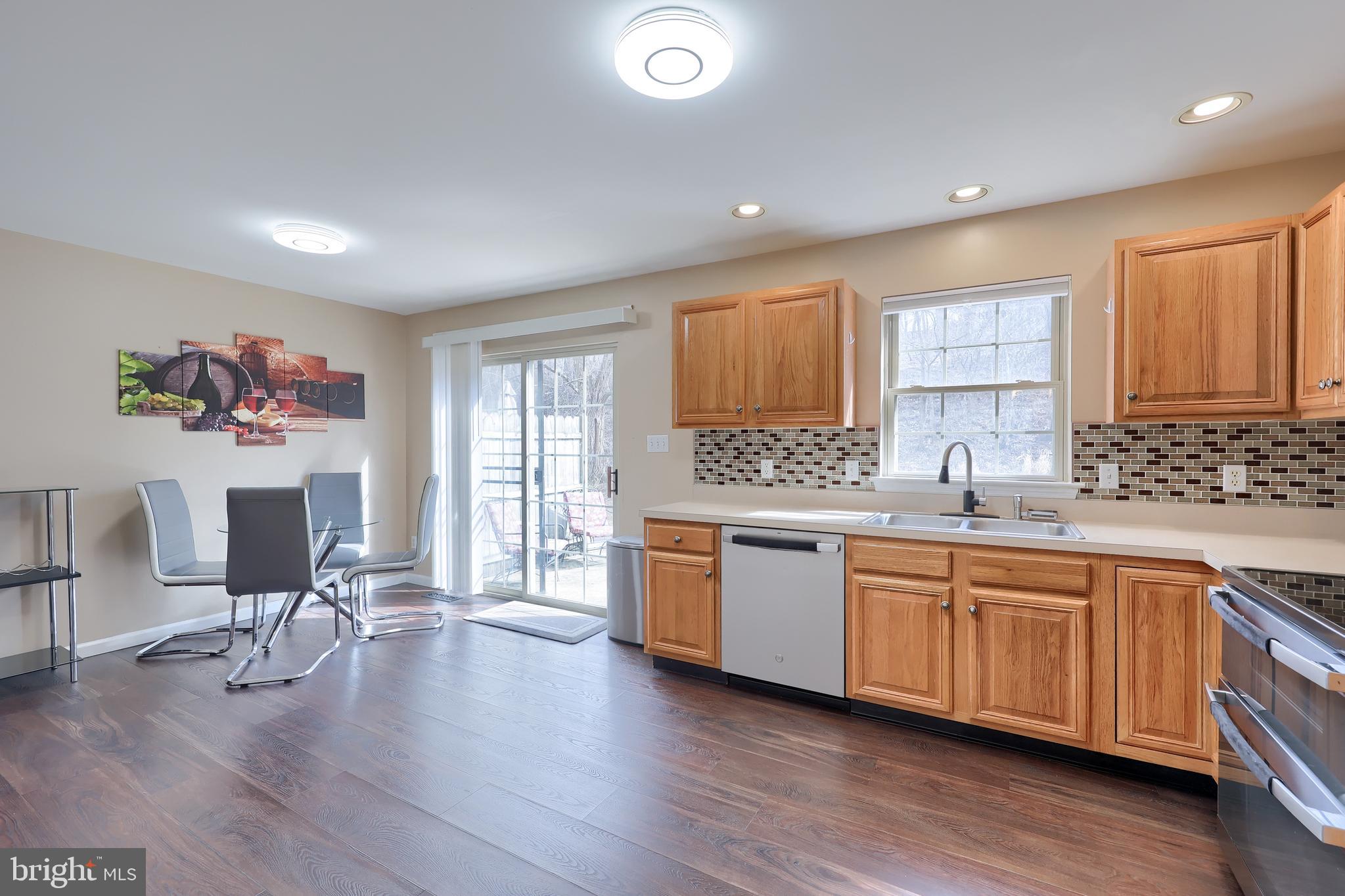 401 Crosswinds Drive Lititz, PA 17543 - Photo 8 of 32 a large kitchen with granite countertop a stove and wooden floor