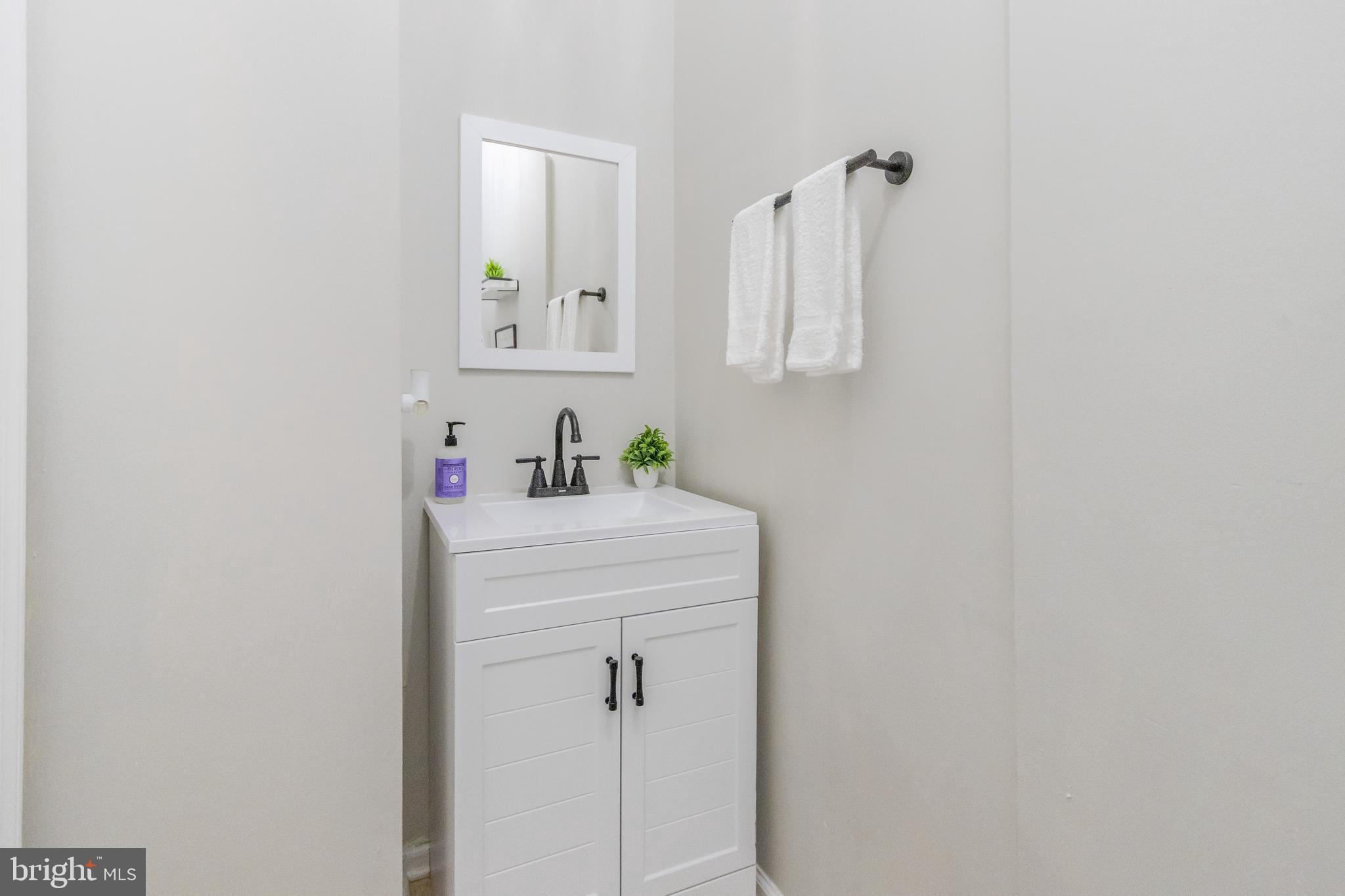 1235 North Bond Street Baltimore, MD 21213 - Photo 7 of 20 a bathroom with a sink and a mirror