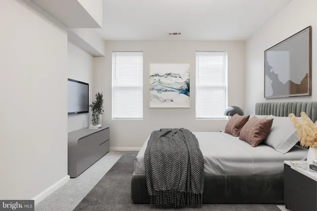 a bedroom with a bed and a couch