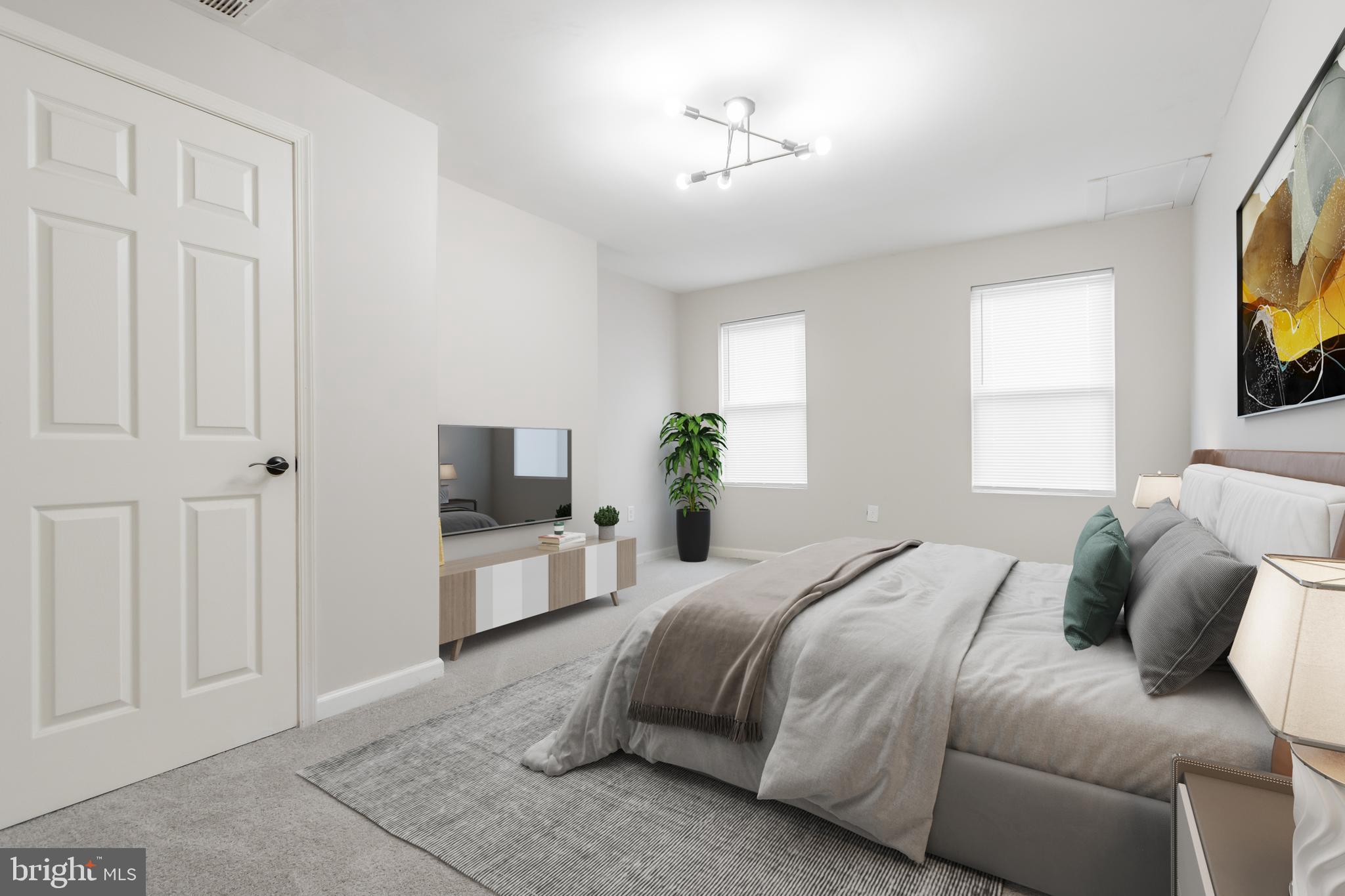 1235 North Bond Street Baltimore, MD 21213 - Photo 10 of 20 a spacious bedroom with a bed and a flat screen tv