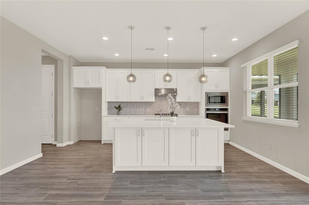 2575 Park Ridge Street Apopka, FL 32712 - Photo 8 of 56 Open kitchen with updated pendant lights