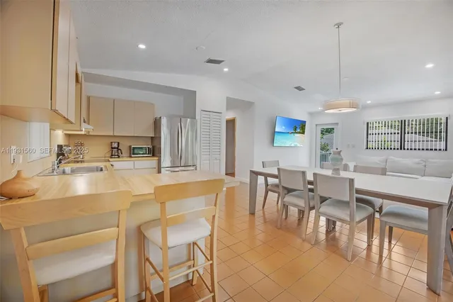 a large kitchen with a table and chairs