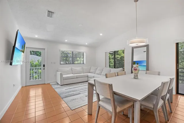 a living room with furniture a window and a chandelier