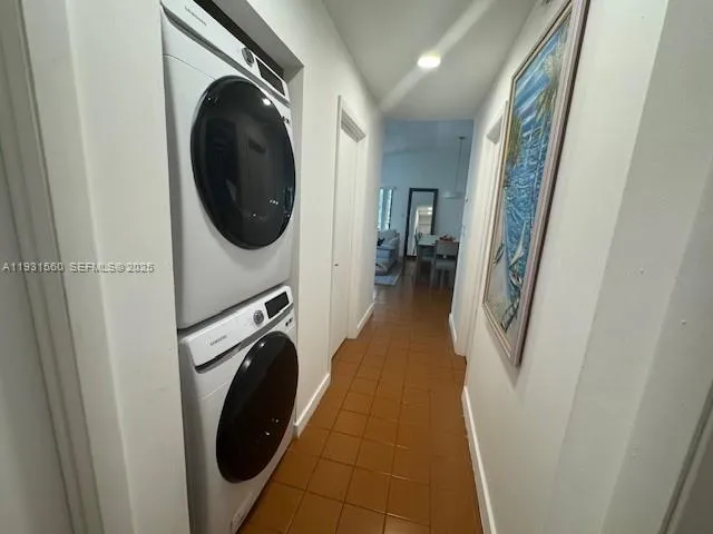 a view of a hallway with washer and dryer