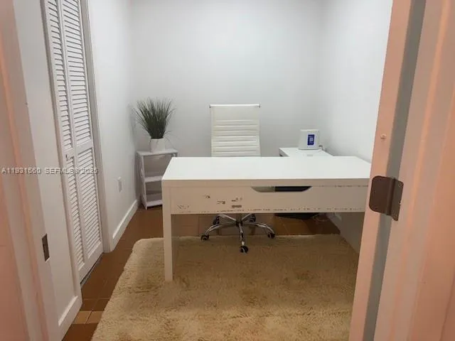a view of a room that has a table and chair in it