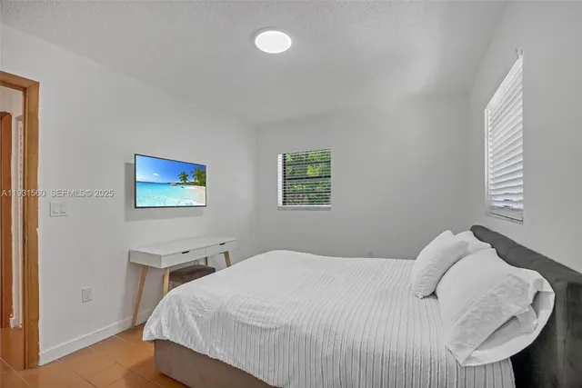 a bedroom with a bed and a night stand