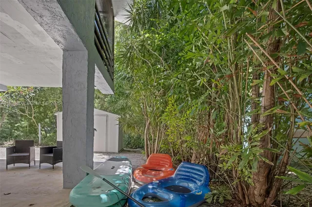a backyard of a house with table and chairs