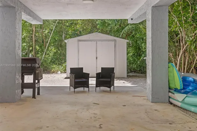 a view of a two chairs in a patio